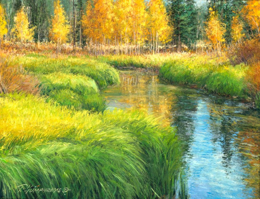 Golden Hour Lush, green grass and autumn trees reflecting in a calm river under clear skies.