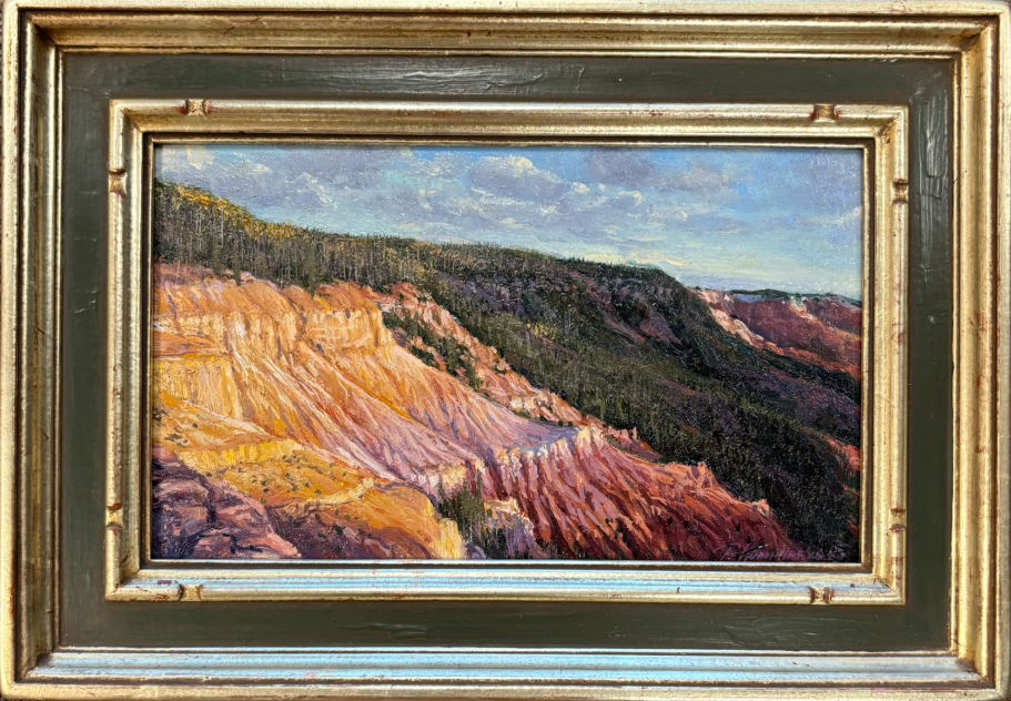 Cedar Breaks Landscape featuring colorful rock formations and distant hills under a cloudy sky.